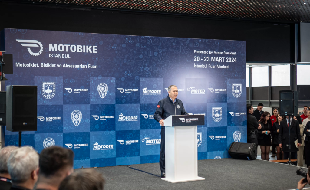 A speaker presenting at a conference, engaging the audience with insights on the latest industry trends